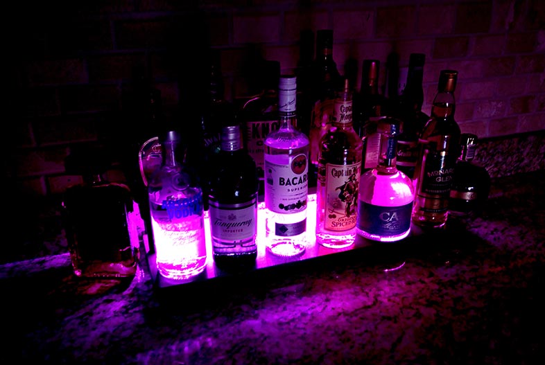 LED Counter Caddies™ - Walnut-Stained Straight Shelf - Liquor/Wine Bottle Display - bright light glow magenta red